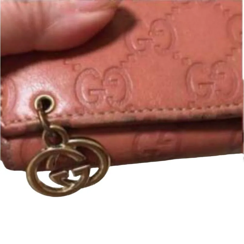 Gucci, salmon colored embossed Guccissima print leather, XL size, wallet on a removable chain